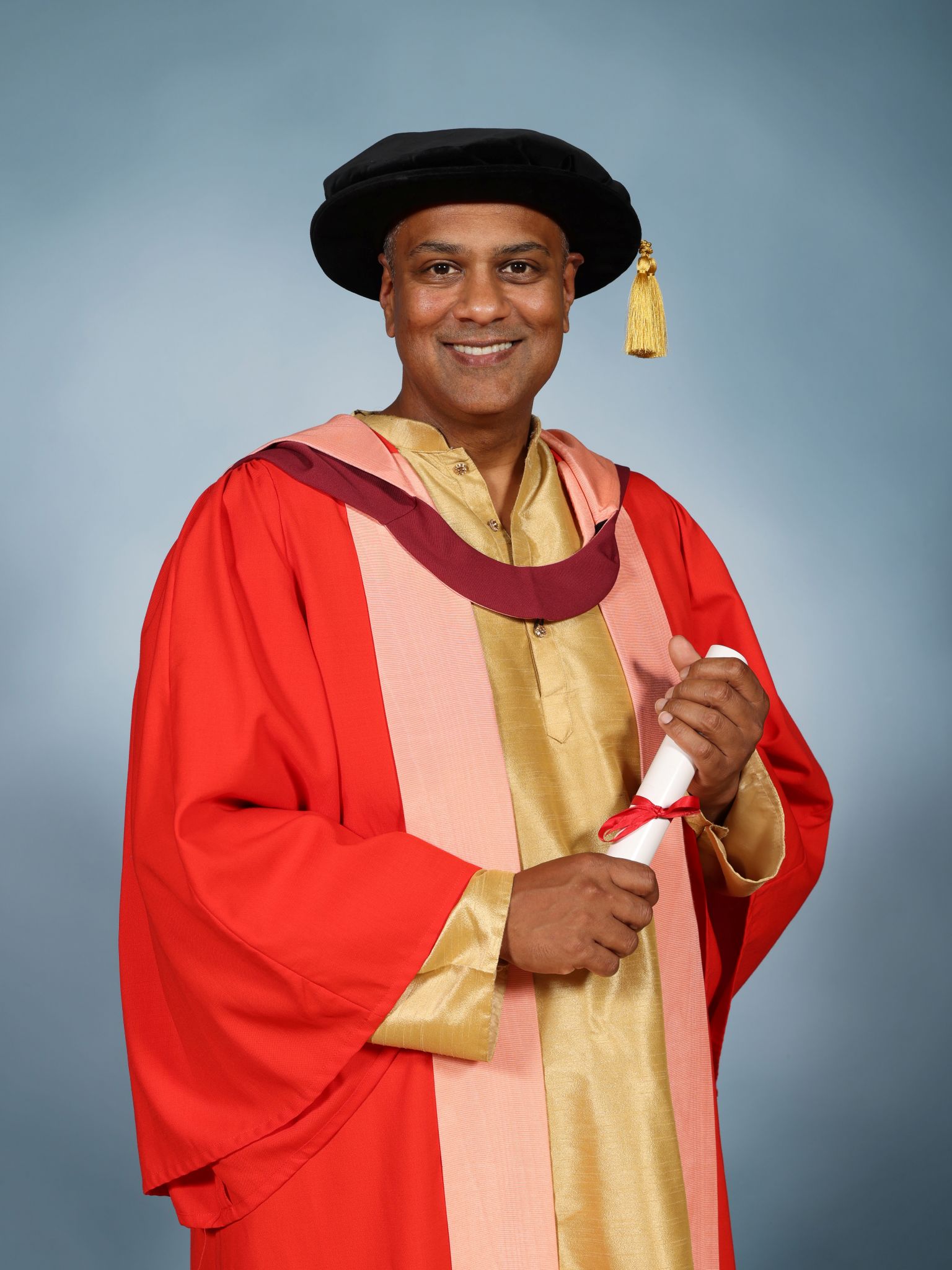 Krishnendu Majumdarwearing a mortar board and holding a parchment